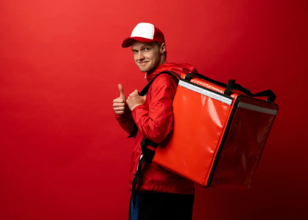 Man with a food delivery bag of a restaurant, giving a thumbs up