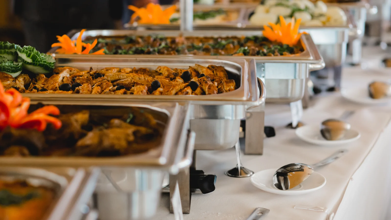 Food in large containers, prepared for some kind of even in a restaurant